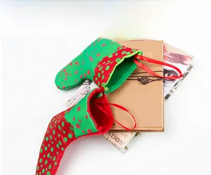 Detail of red and green polka dot Christmas stocking bags with hanging ribbons