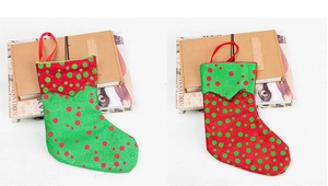 Detail of red and green polka dot Christmas stockings with hanging loops and burlap texture