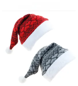 Detail of red and grey knitted Christmas hats with plush white faux fur trim and pom-poms