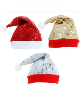 Detailed view of red, gold, and silver mesh Christmas hats with star prints and plush trim