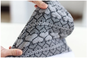 Detail shot of grey and black jacquard knitted fabric with elastic heart pattern texture