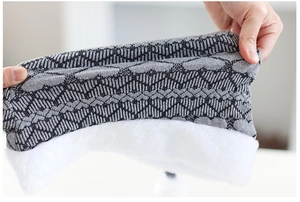 Detail of high-elasticity knitted Christmas hat with thick white plush lining for warmth