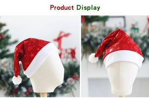 Detail of red mesh Christmas hat with gold star prints and white plush trim