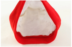 Detail of red velvet Christmas bag with star pattern lining and gold stitched hem