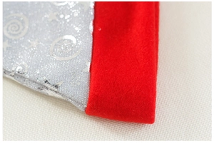 Detail of red felt trim and silver glitter star patterns on a mesh Christmas hat