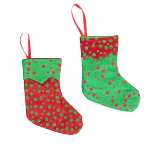 Set of two red and green polka dot Christmas stocking hanging ornaments in rustic burlap