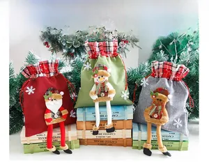Detail of Christmas burlap gift bags featuring long-legged Santa, Snowman and Reindeer dolls