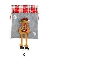 Detail of grey burlap Christmas gift bag featuring a 3D plush reindeer with long legs