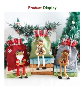 Detailed view of three burlap Christmas gift bags with 3D dangling leg characters