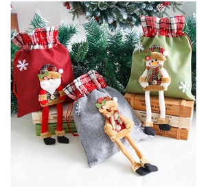 Detailed view of Christmas burlap gift bags featuring 3D Santa, Snowman and Reindeer dolls