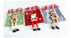 Detailed view of Christmas burlap drawstring gift bags with 3D plush holiday characters