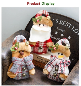 Detail of Christmas plush gift bags featuring Santa, snowman, and reindeer with bells
