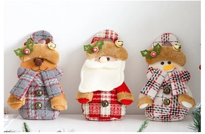 Detailed view of Christmas fabric gift bags featuring Santa, elk, and snowman motifs