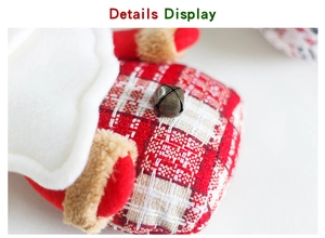 Detail display of Christmas fabric ornament with plaid pattern and small bronze bell