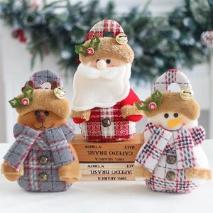 Three Christmas plush gift bags featuring Santa, reindeer, and snowman on wooden crates