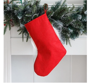 Grande chaussette de Noël en lin avec bord en peluche et attache sur une cheminée