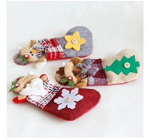 Detail of mini burlap Christmas stockings with Santa, snowman and reindeer designs