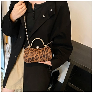 Detail of leopard print evening bag with gold handle and sparkling rhinestone clasp