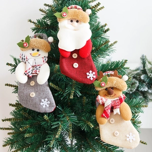 Set of three cartoon Christmas stockings featuring Santa, Snowman, and Reindeer on a tree