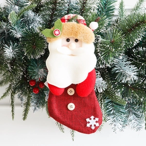 Mini Christmas stocking with 3D Santa Claus figure on rustic red burlap background
