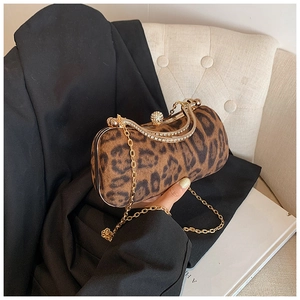 Detail of leopard print evening bag with rhinestone clasp and gold chain strap