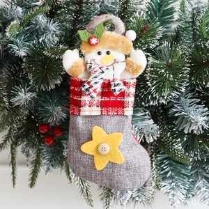 Hanging burlap Christmas stocking with 3D snowman character and festive plaid cuff decor