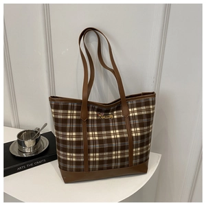 Close-up of vintage plaid tote bag featuring intricate puppy embroidery and leather straps