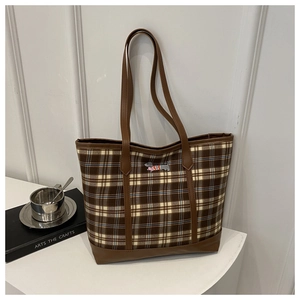 Detail of checkered tote bag featuring a cute dachshund embroidery and leather handles