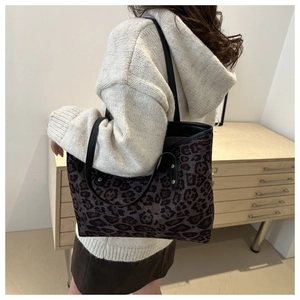 Detailed shoulder view of large leopard print tote bag with dark brown suede texture