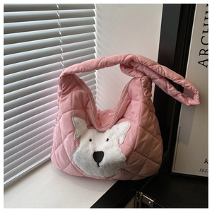 Detail of pink quilted tote bag with a cute puppy patch and soft woven handles
