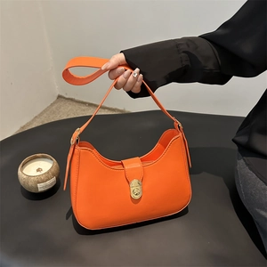 Modern orange leather half-moon shoulder bag with golden clasp and adjustable strap