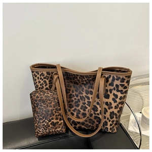 Detail shot of leopard print tote bag with matching inner pouch and brown leather trim