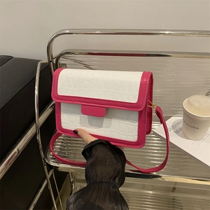 Stylish white croco-embossed crossbody bag with pink trim and golden hardware