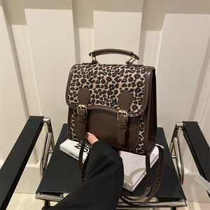 Fashionable leopard print backpack for women with brown leather trim and dual buckles