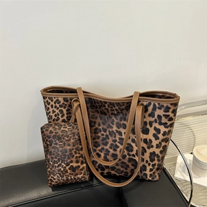 Stylish large leopard print tote bag with matching pouch on a sofa, 2024 fashion collection