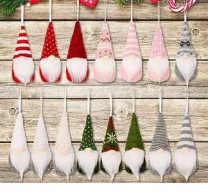 Detailed view of 15 various knitted Christmas gnome ornaments with colorful patterns