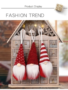 Close-up of three knitted Christmas gnomes with heart patterns and plush fur details