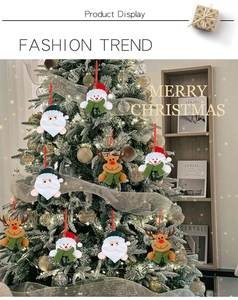 Figurines de Noël en peluche avec cloches suspendues sur un sapin décoré de fêtes