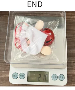 Detailed view of Santa Christmas bell ornament weighing 21.0g on a digital scale