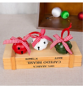 Detailweergave van 5cm kerstbelletjes met rode strikken op een houten decoratie