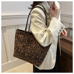 Fashionable leopard print tote bag paired with a beige corduroy blazer in a modern interior