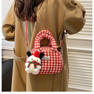 Detail of red checkered plush handbag with snowman charm and detachable shoulder strap