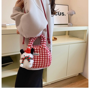 Detail of red and white checkered plush bag with cute snowman charm for winter styling