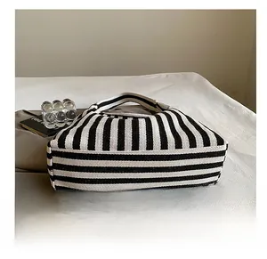 Detail of high-quality striped canvas tote showing durable wear-resistant bottom structure