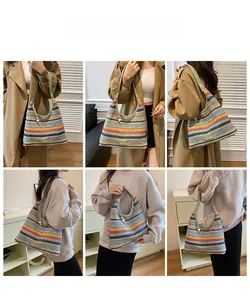 Detailed view of colorful striped woven hobo bag featuring green strap and bead charm