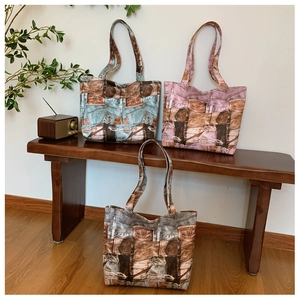 Close-up of three vintage denim print canvas tote bags in a retro studio setting