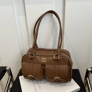 Brown leather shoulder bag with gold Akobia People logo and front flap pockets