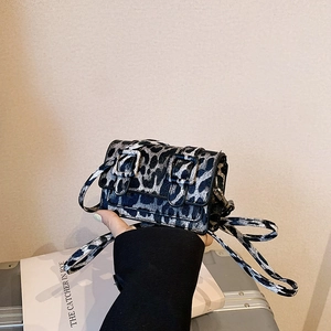 Stylish leopard print mini crossbody bag with silver buckles and adjustable strap