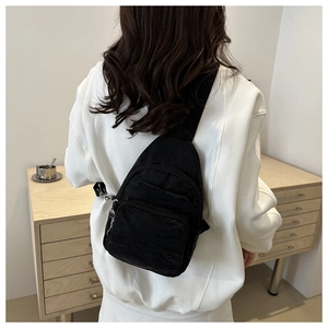 Detailed close-up of a black multi-zipper casual chest bag with durable nylon texture