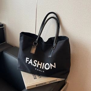 Black canvas tote bag with Fashion Paris print and leather handles for office commuting